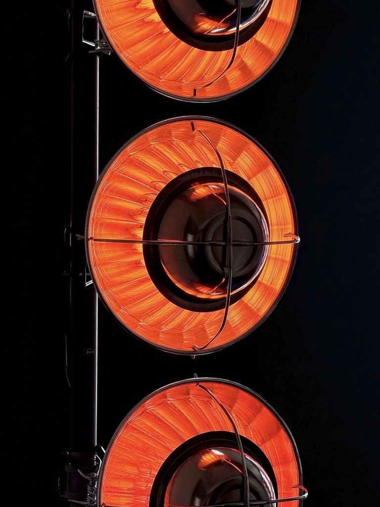 Close-up of three amber lights against black